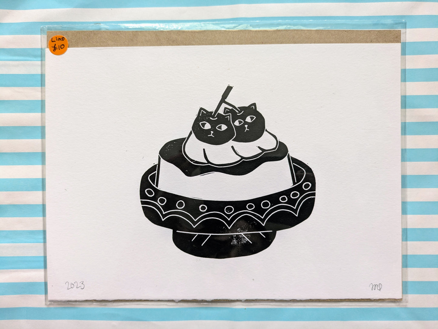 lino cutting print of a purin/pudding with cats