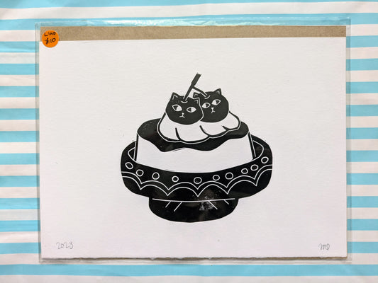 lino cutting print of a purin/pudding with cats
