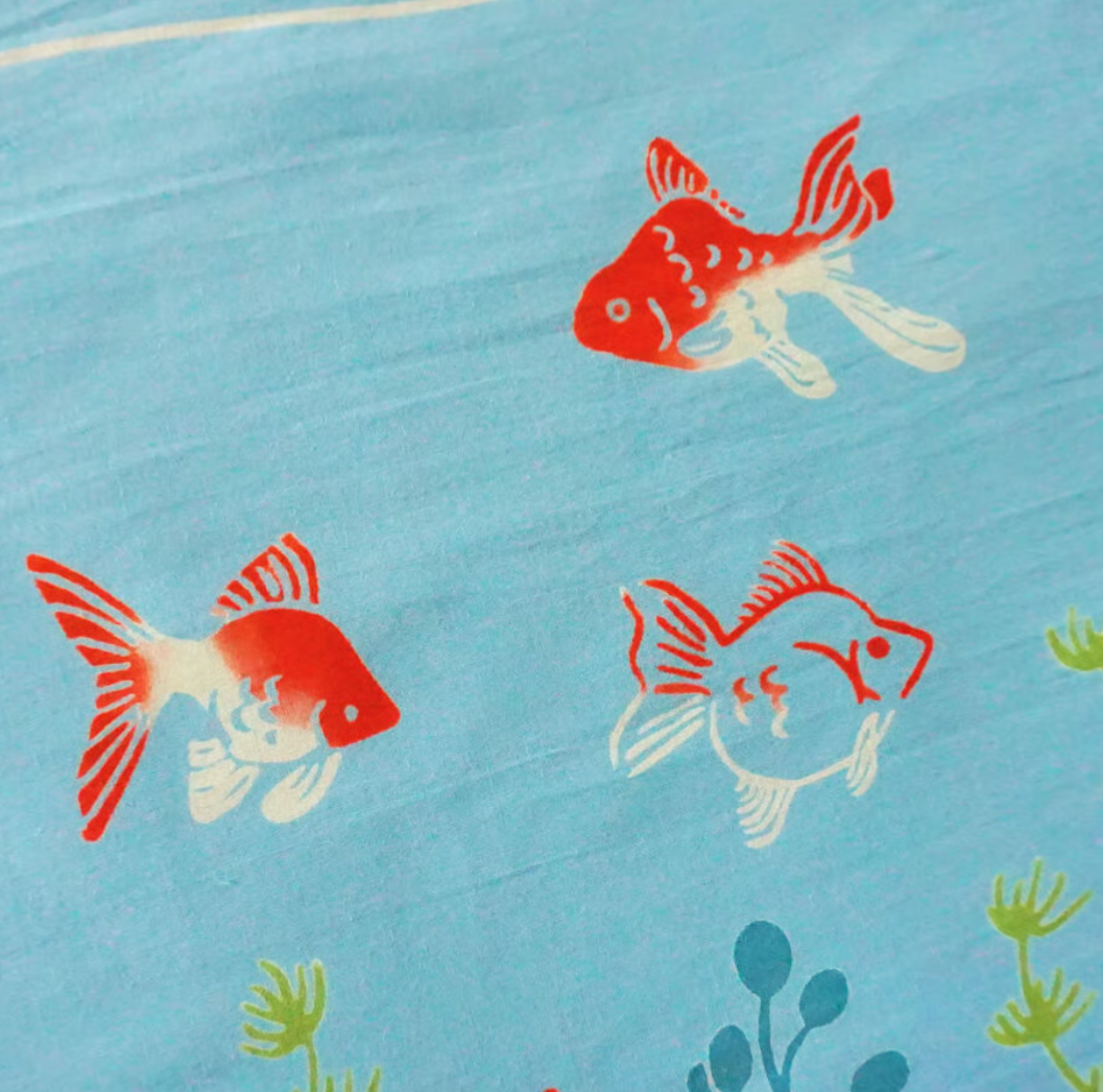 Red and white fish illustrations on a blue background with green plants.