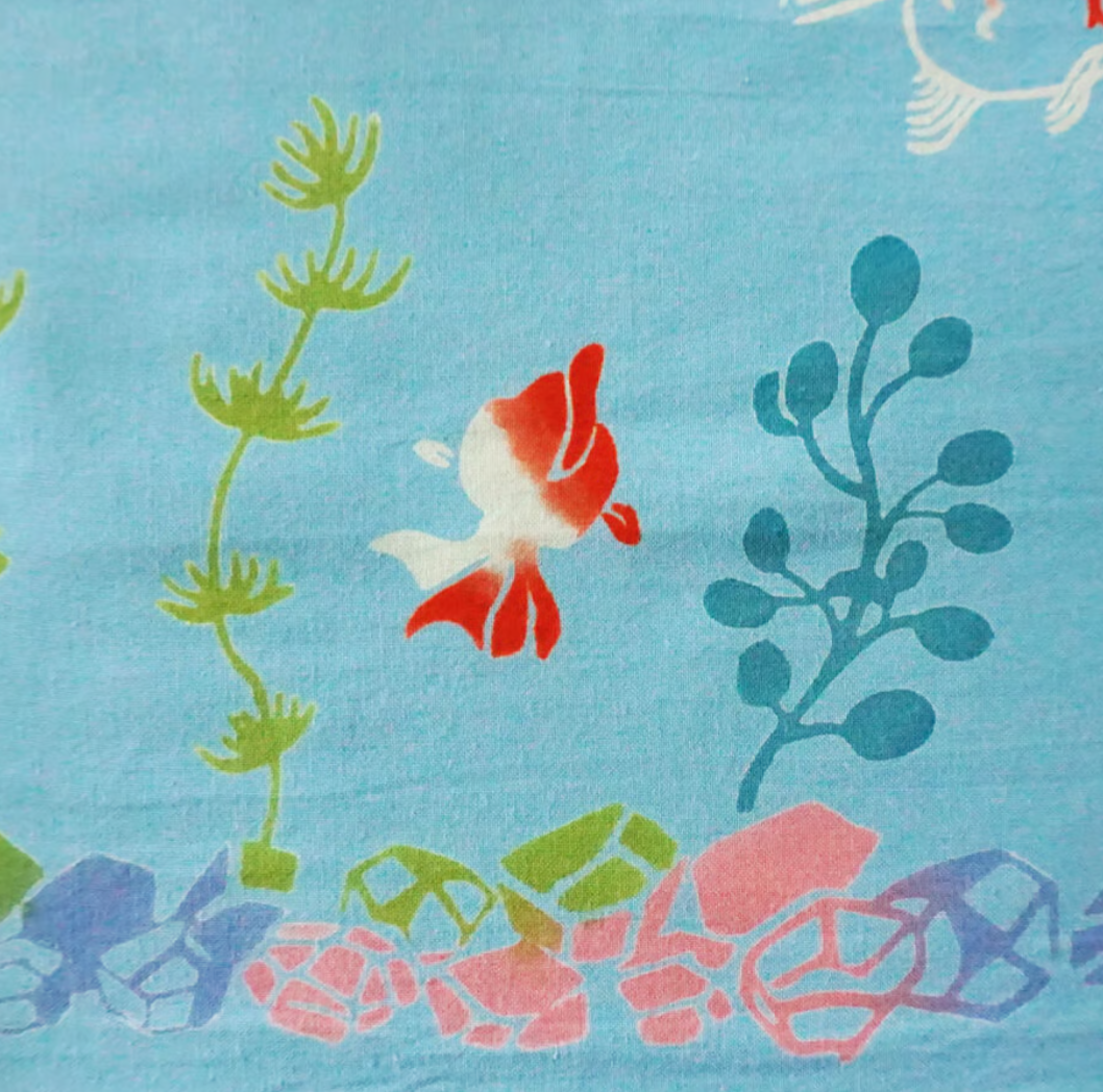 Fabric with fish and underwater plant pattern on a blue background