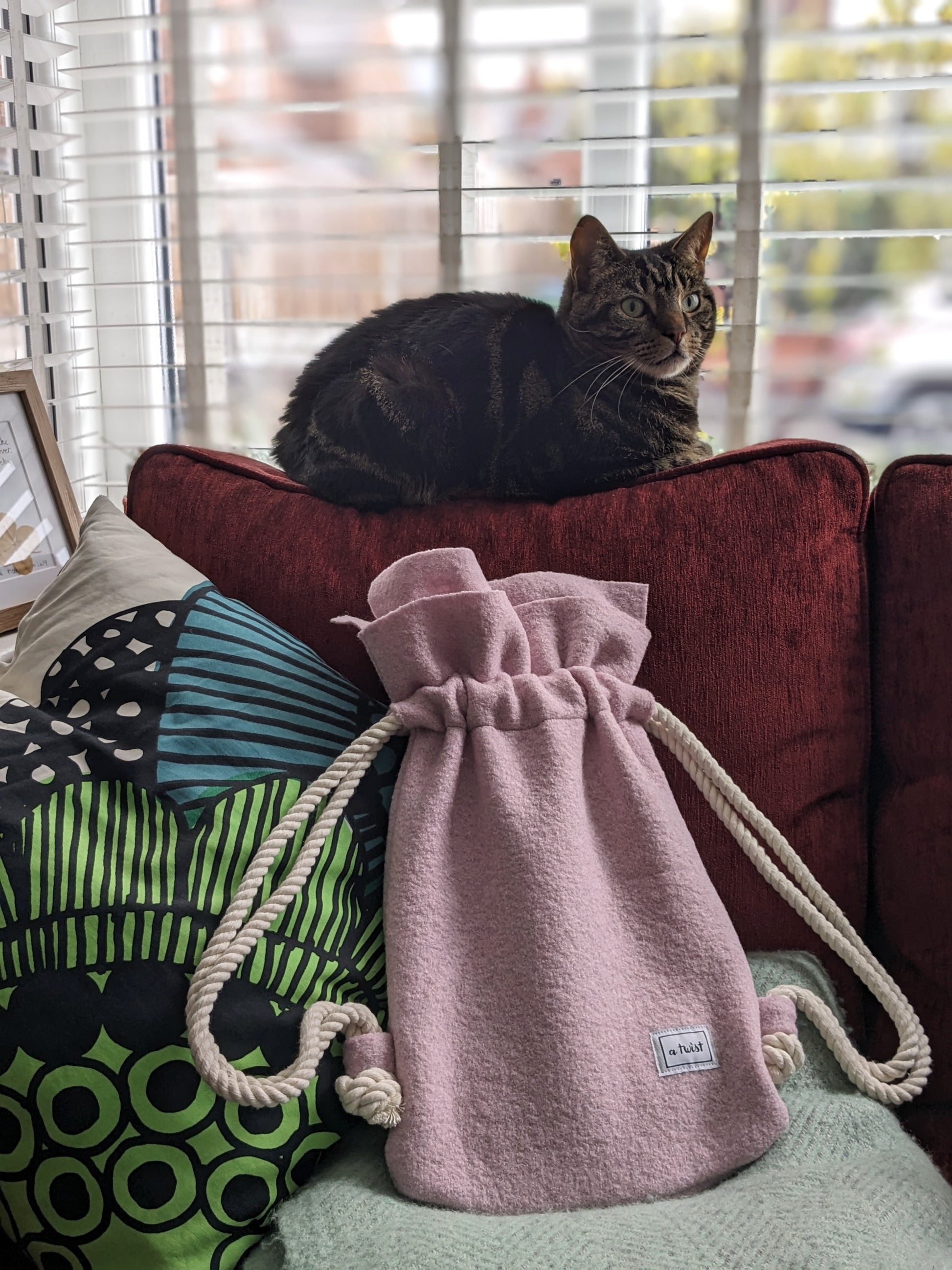 Hot Water Bottle Bag pink on the sofa