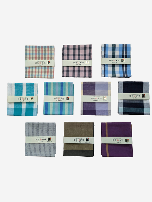 Collection of folded Ise Momen Handkerchief in various colours and patterns on a white background.