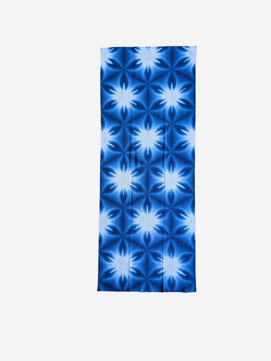 Blue and white patterned Tenugui towel on a white background