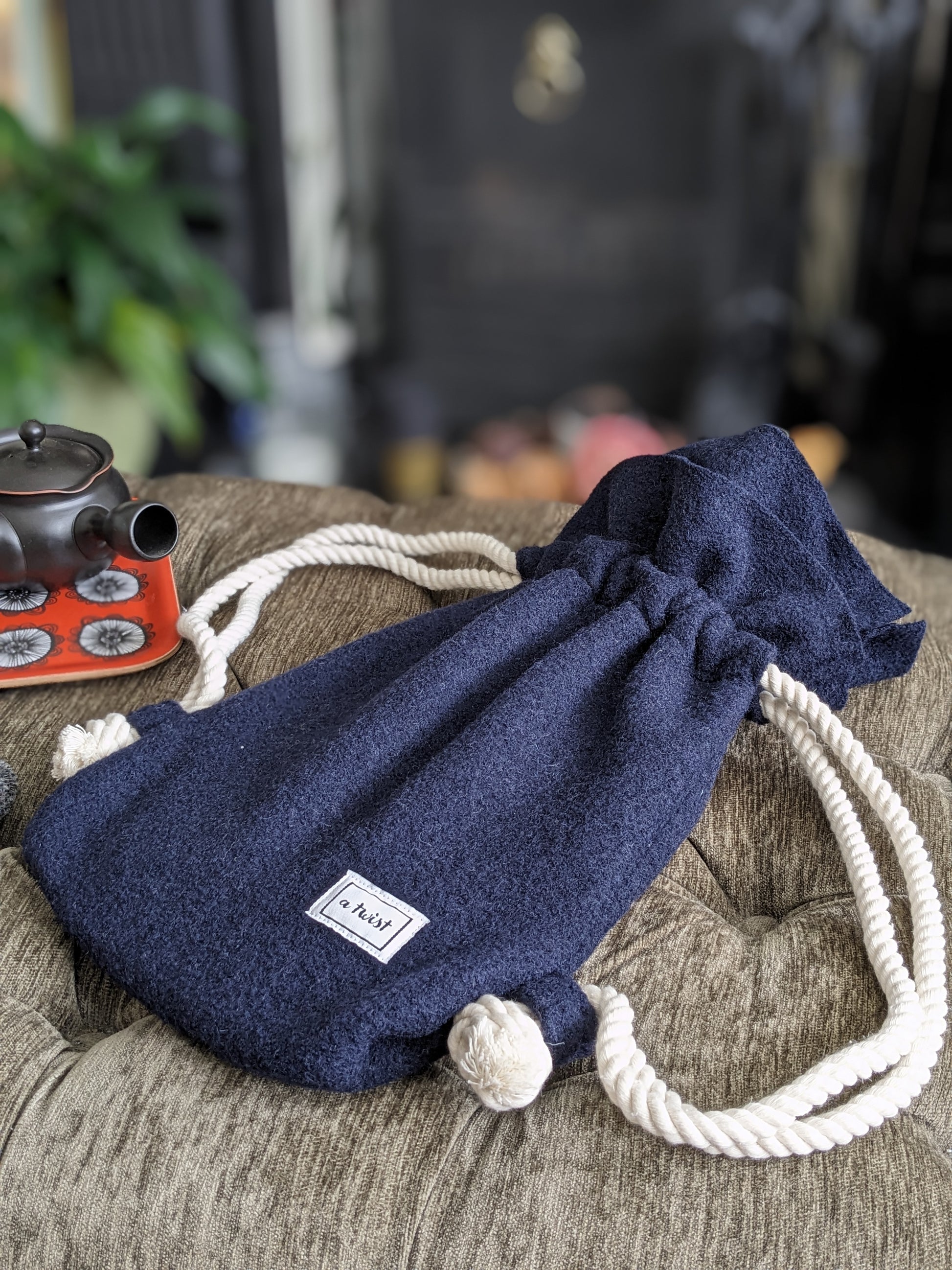 Hot Water Bottle Bag navy on the foot stool