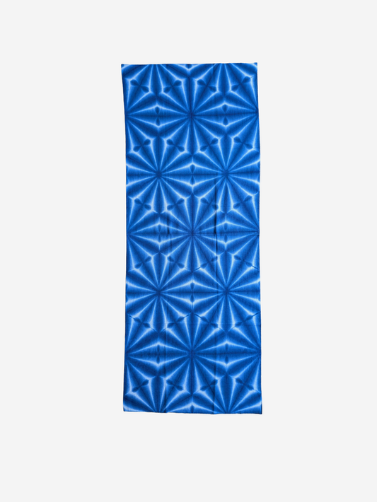Blue geometric patterned tenugui towel on a white background