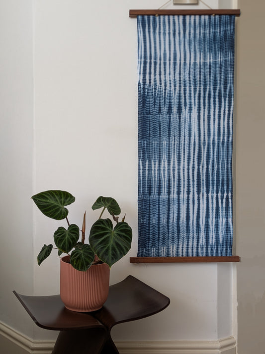 Tesuji Shibori Indigo Tenugui on a wall — Hand-Pleated, Rope-Bound Resist Dyeing