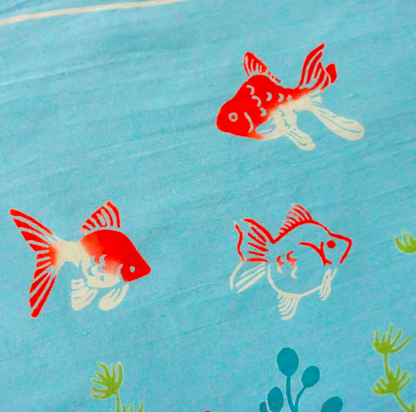 Red and white fish illustrations on a blue background with green plants.