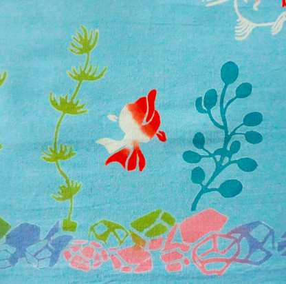 Fabric with fish and underwater plant pattern on a blue background