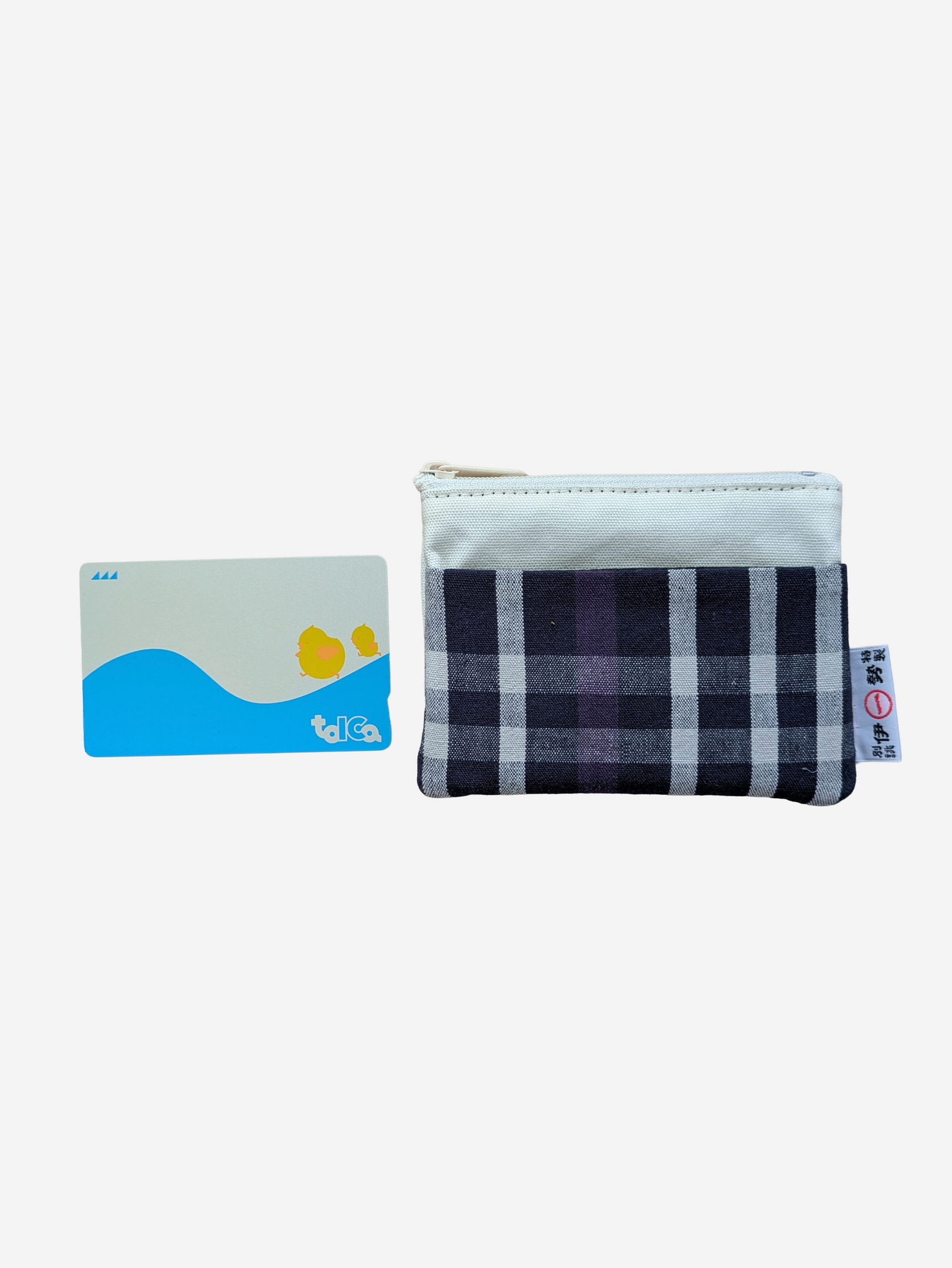 A small zippered pouch with a navy, black, and white plaid front and a light blue fabric top, shown next to a blue and white card with yellow duck illustrations on a plain white background.